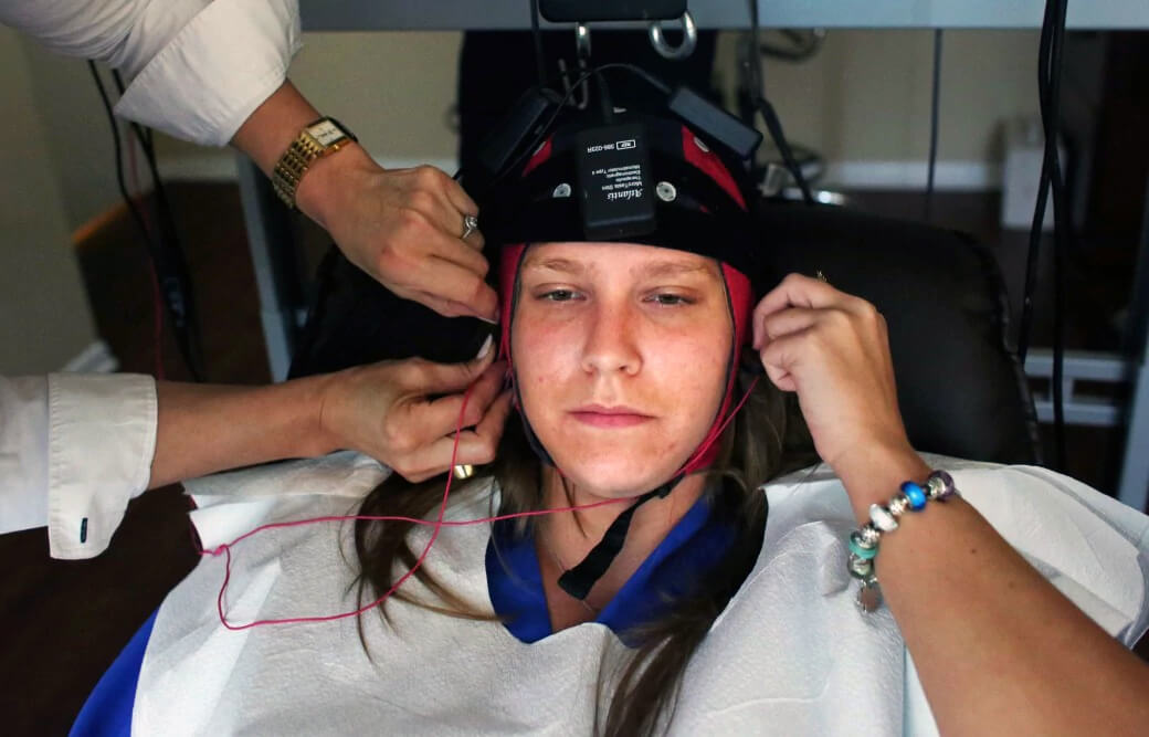 Marris Szeliga, a patient and employee of psychiatrist Hasan Asif, is fitted with an EEG cap that will allow him to analyze her brain-wave activity